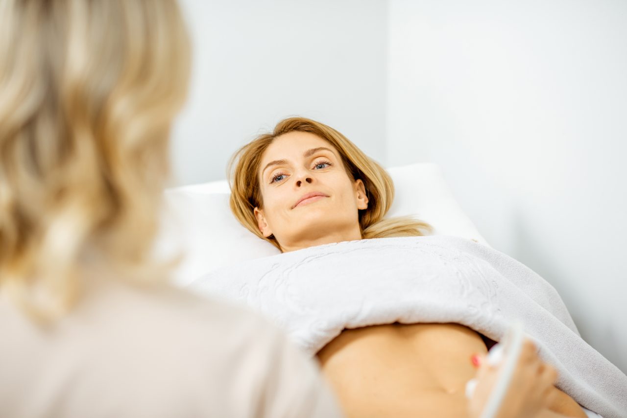 woman-examining-her-abdomen-with-ultrasound-2022-01-18-23-54-10-utc-1-1280x854.jpg